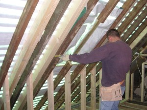 Builder working inside a roof